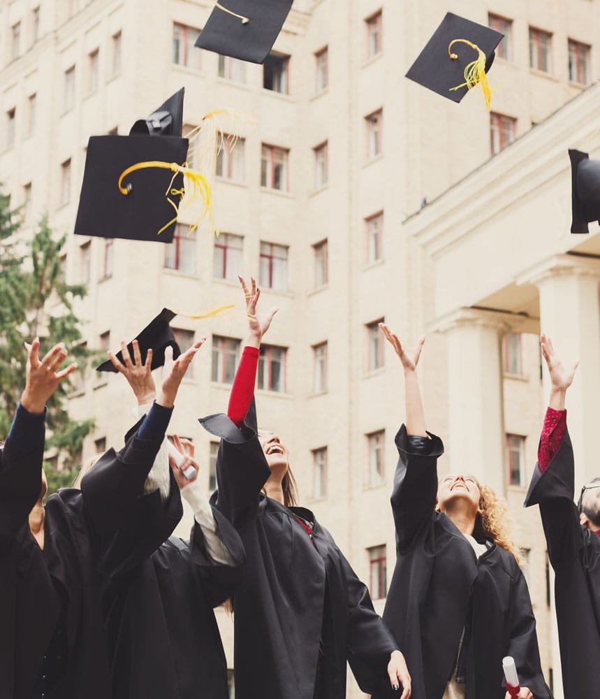 Graduates celebrating together outdoors